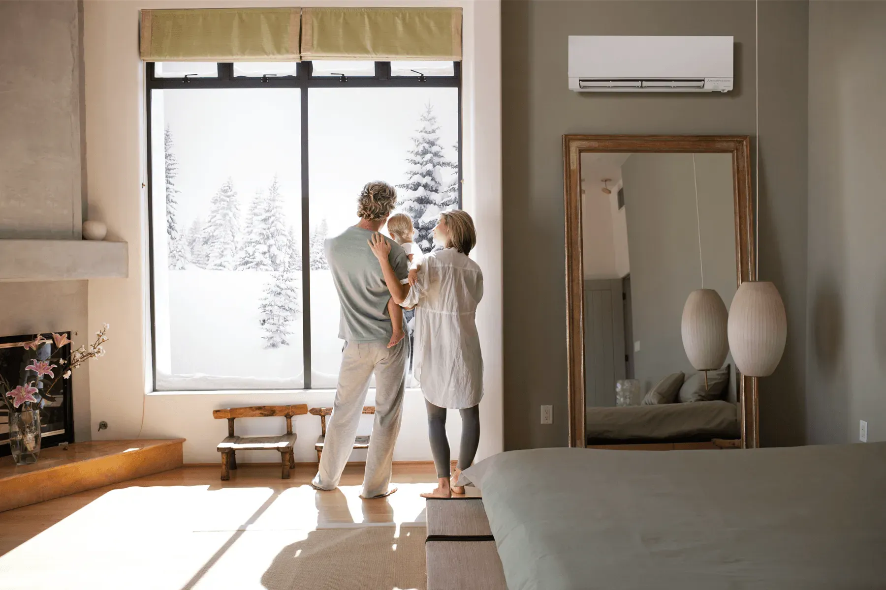 Family enjoying there Mitsubishi ductless mini-split during a snow storm